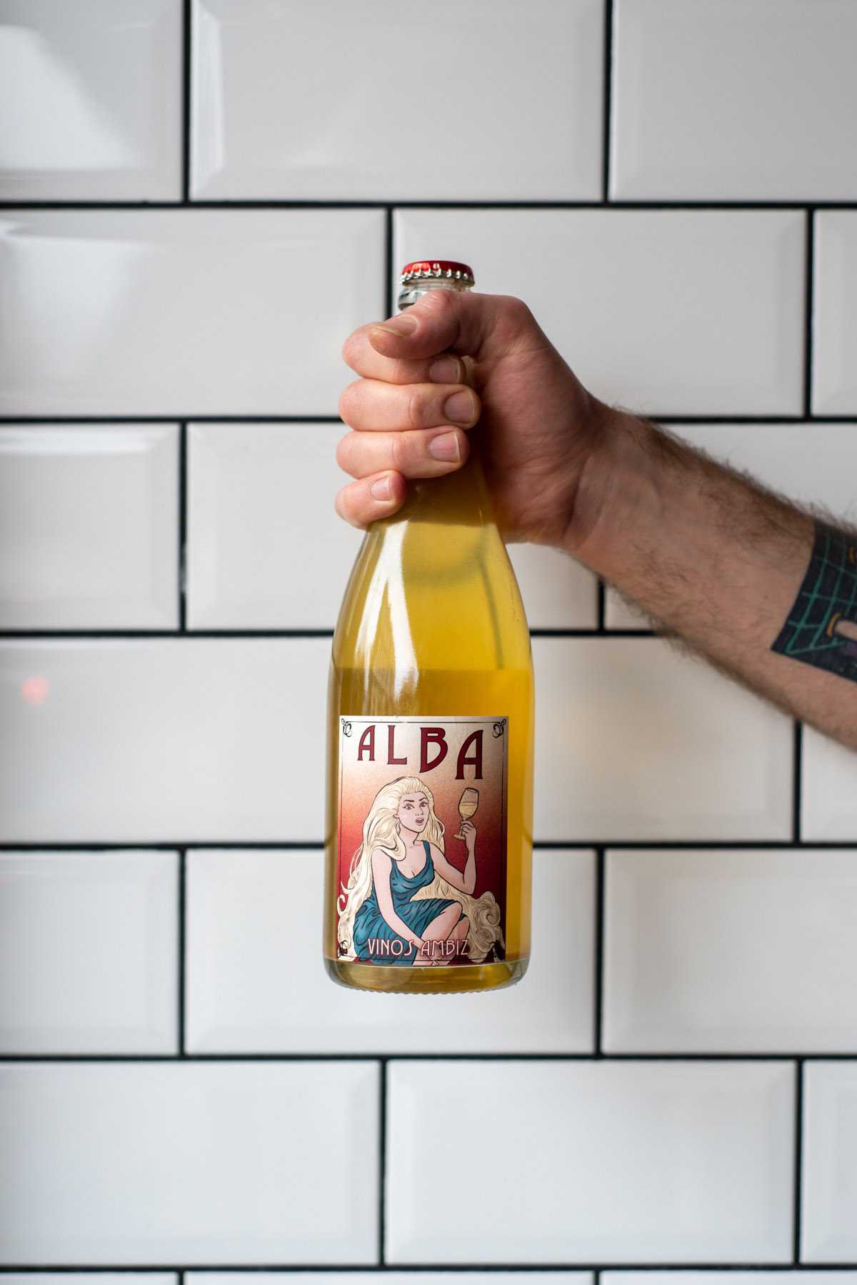 a hand holding a wine bottle